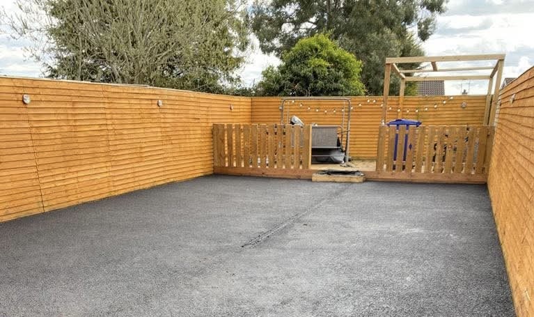 Professional wooden fence installation with horizontal slats and gate